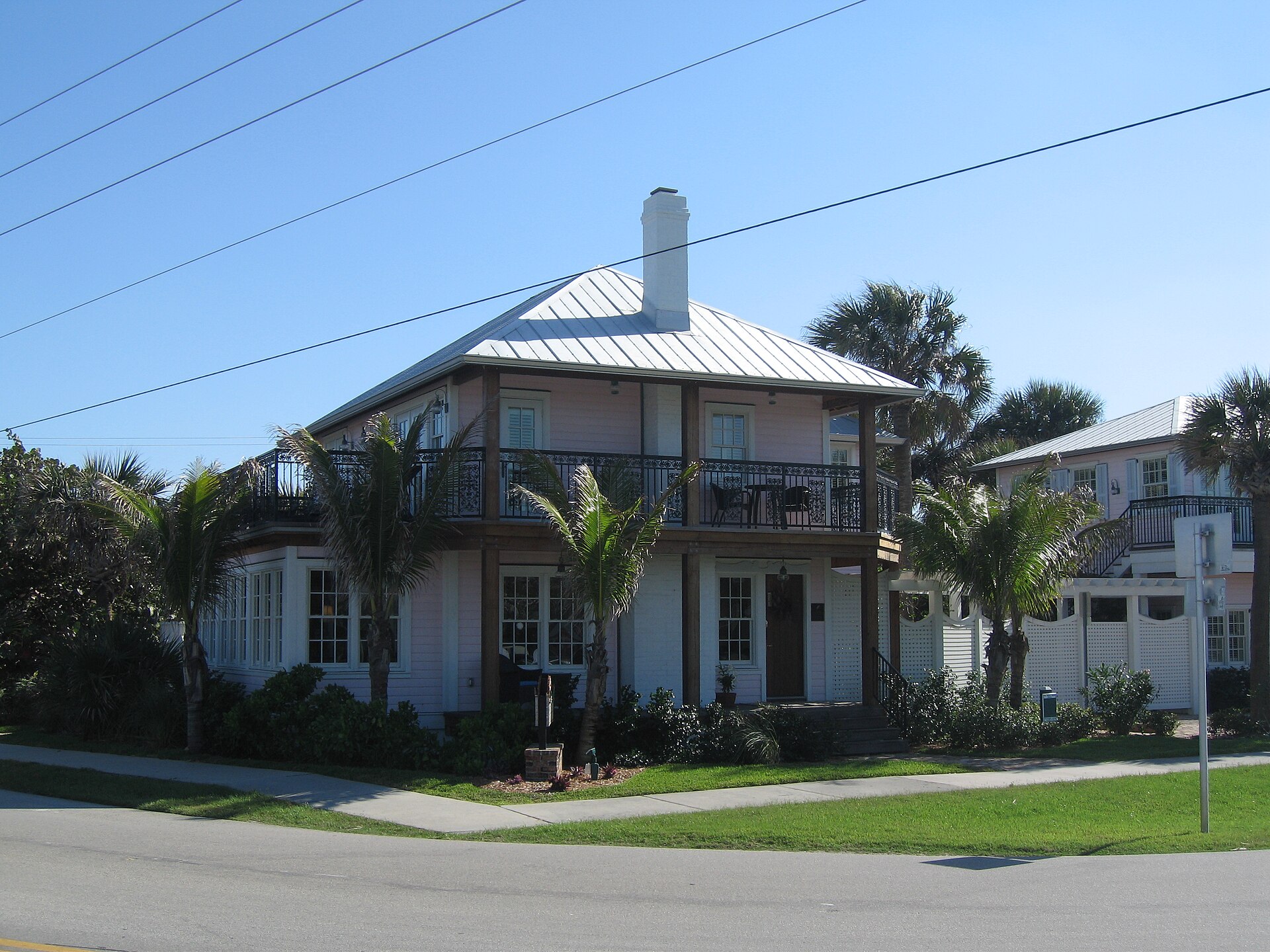 The Pink House at Melbourne Beach, Florida, a historic painted residence visible from the road.